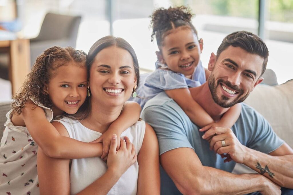 young family smiling after securing a family health insurance plan
