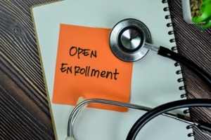 open enrollment note on notebook and sthethoscope